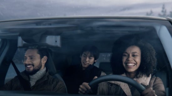 Three passengers riding in a vehicle and smiling | Lupient Nissan in Brooklyn Park MN
