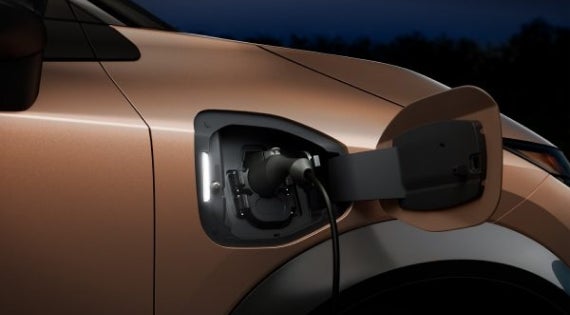 Close-up image of charging cable plugged in | Lupient Nissan in Brooklyn Park MN