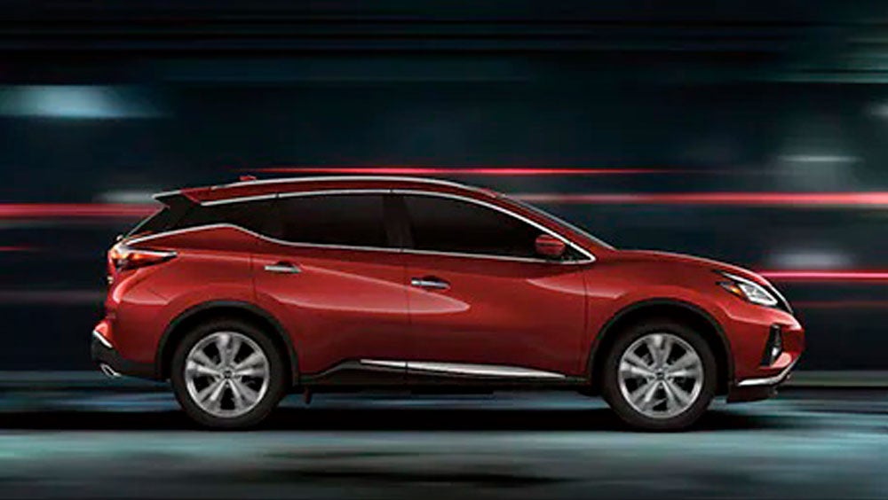 2023 Nissan Murano shown in profile driving down a street at night illustrating performance. | Lupient Nissan in Brooklyn Park MN