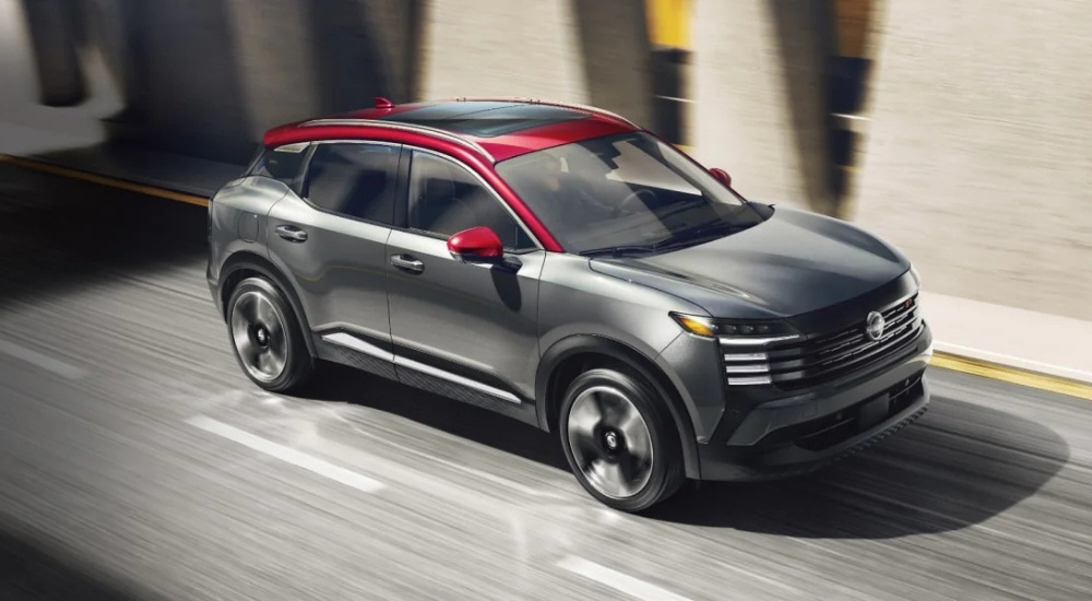 A grey 2025 Nissan Kicks SR is shown from the front at an angle after leaving a Nissan dealer.