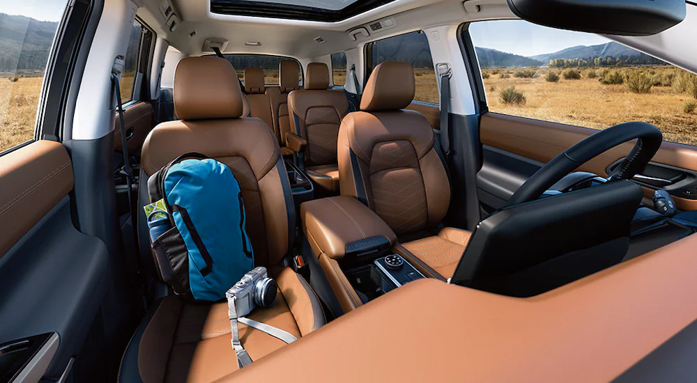 Three rows of brown leather seating in a 2025 Nissan Pathfinder for sale.