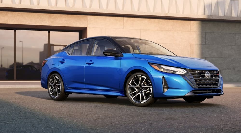 Blue 2025 Nissan Sentra parked outside a building.