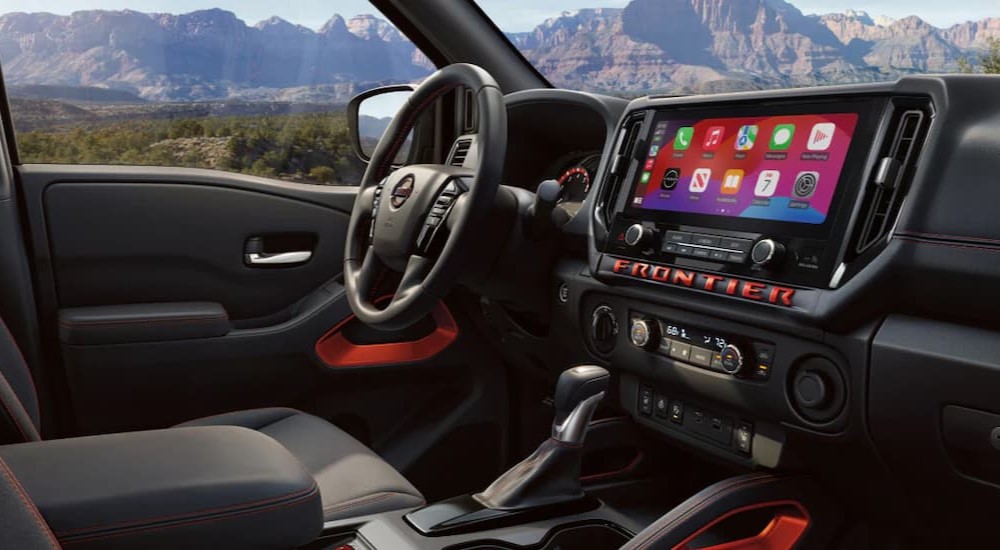 The black dash in a 2025 Nissan Frontier at a Nissan dealer near Golden Valley.