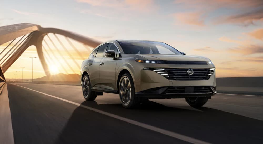A tan 2025 Nissan Murano driving on a bridge