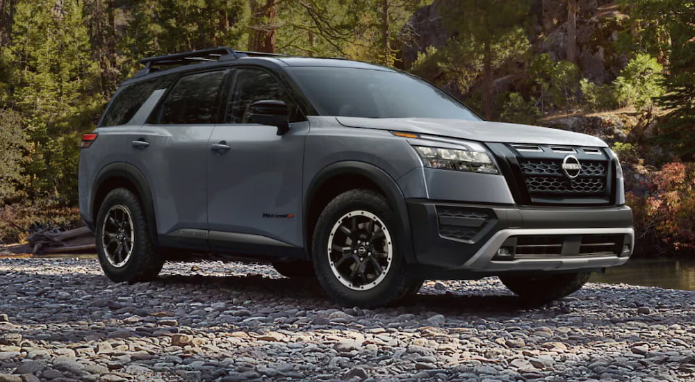 Grey 2025 Nissan Pathfinder Rock Creek for sale in Brooklyn Park parked off-road on a riverbed.