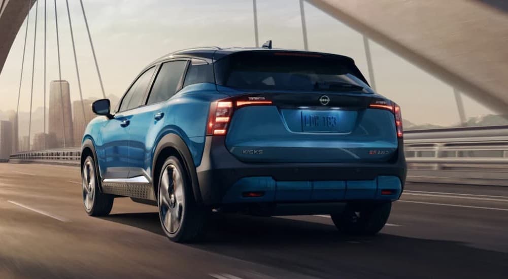A blue 2026 Nissan Kicks driving in a tunnel.