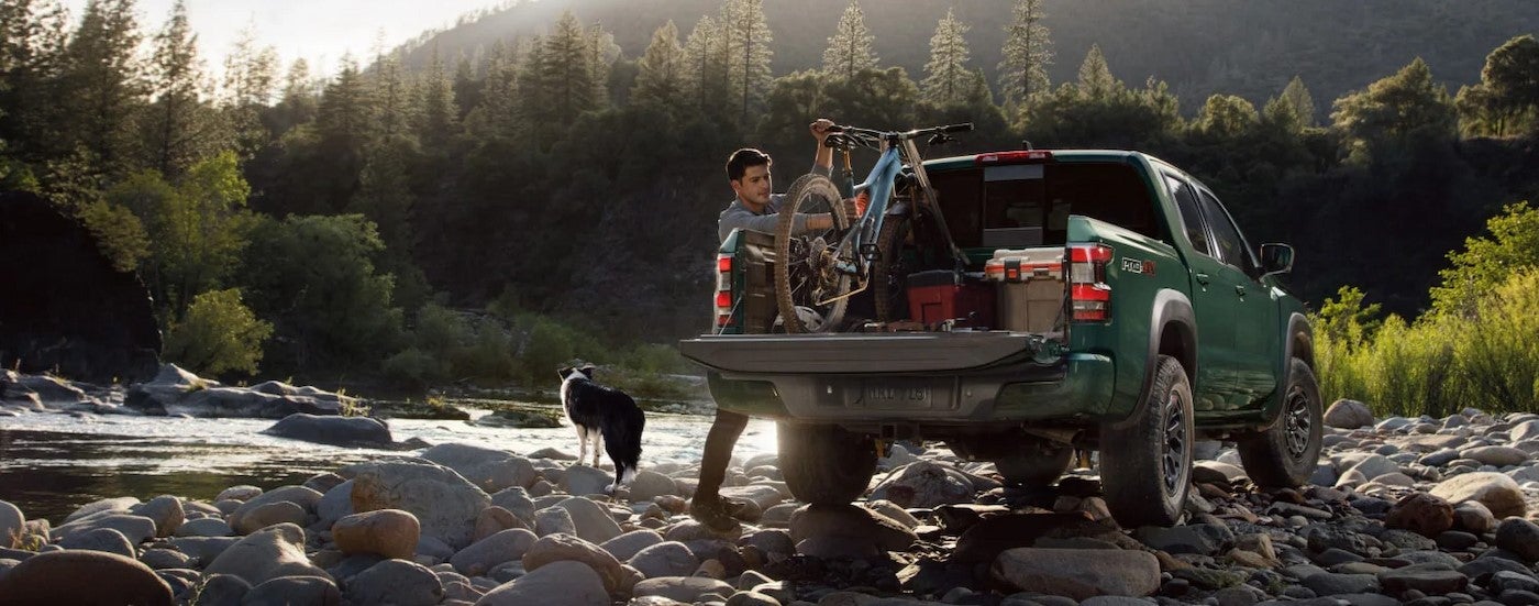 A green 2025 Nissan Frontier Pro-4X parked off-road.
