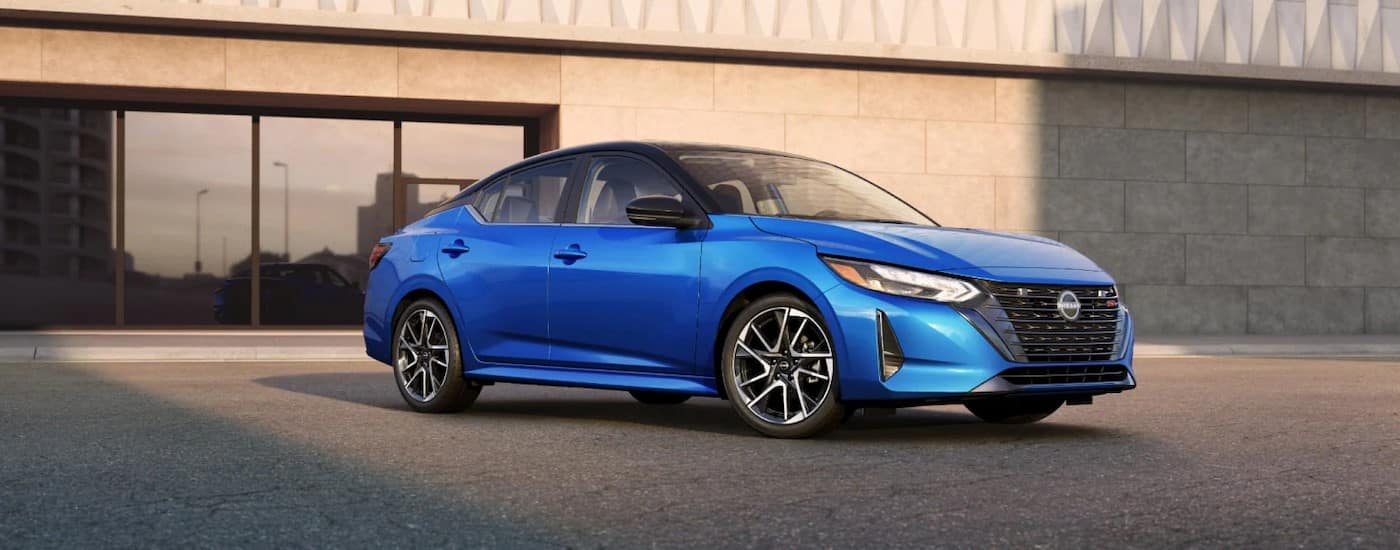 A blue 2025 Nissan Sentra SR parked at a Nissan dealer near Golden Valley.