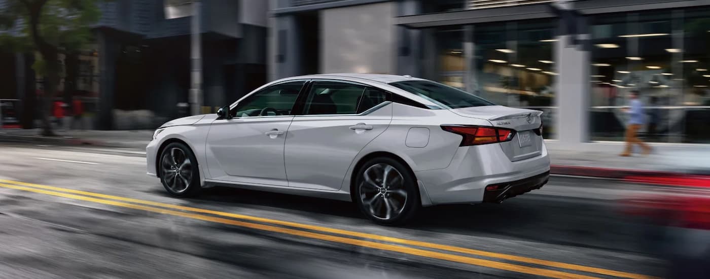 A silver 2025 Nissan Altima driving in the rain