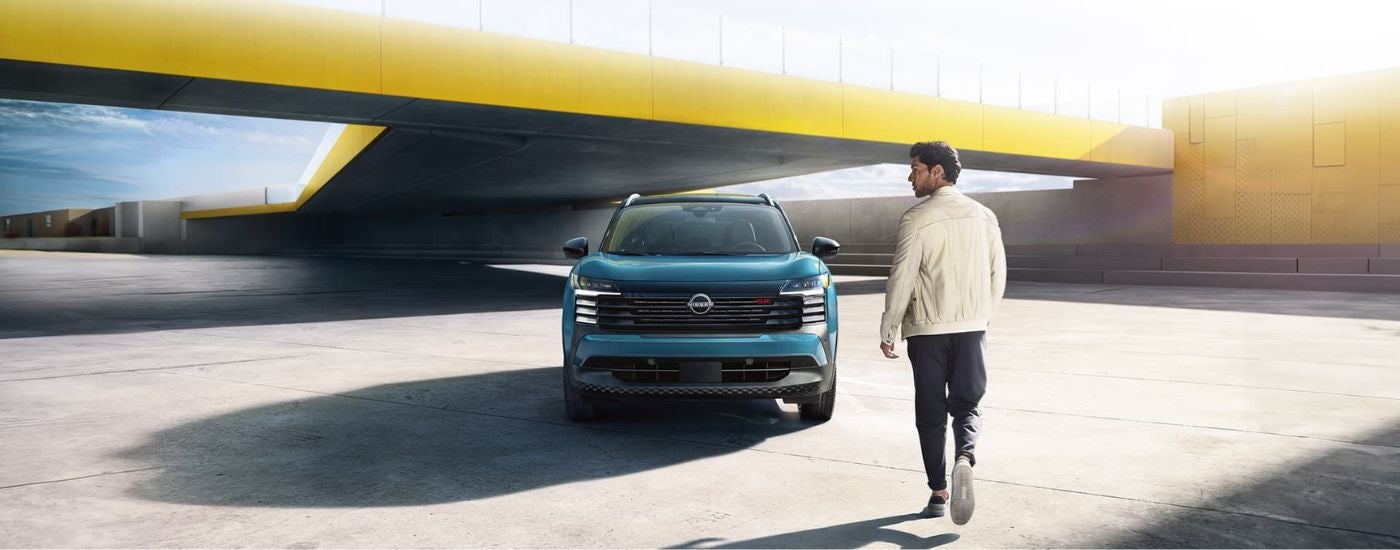 A blue 2025 Nissan Kicks parked for sale